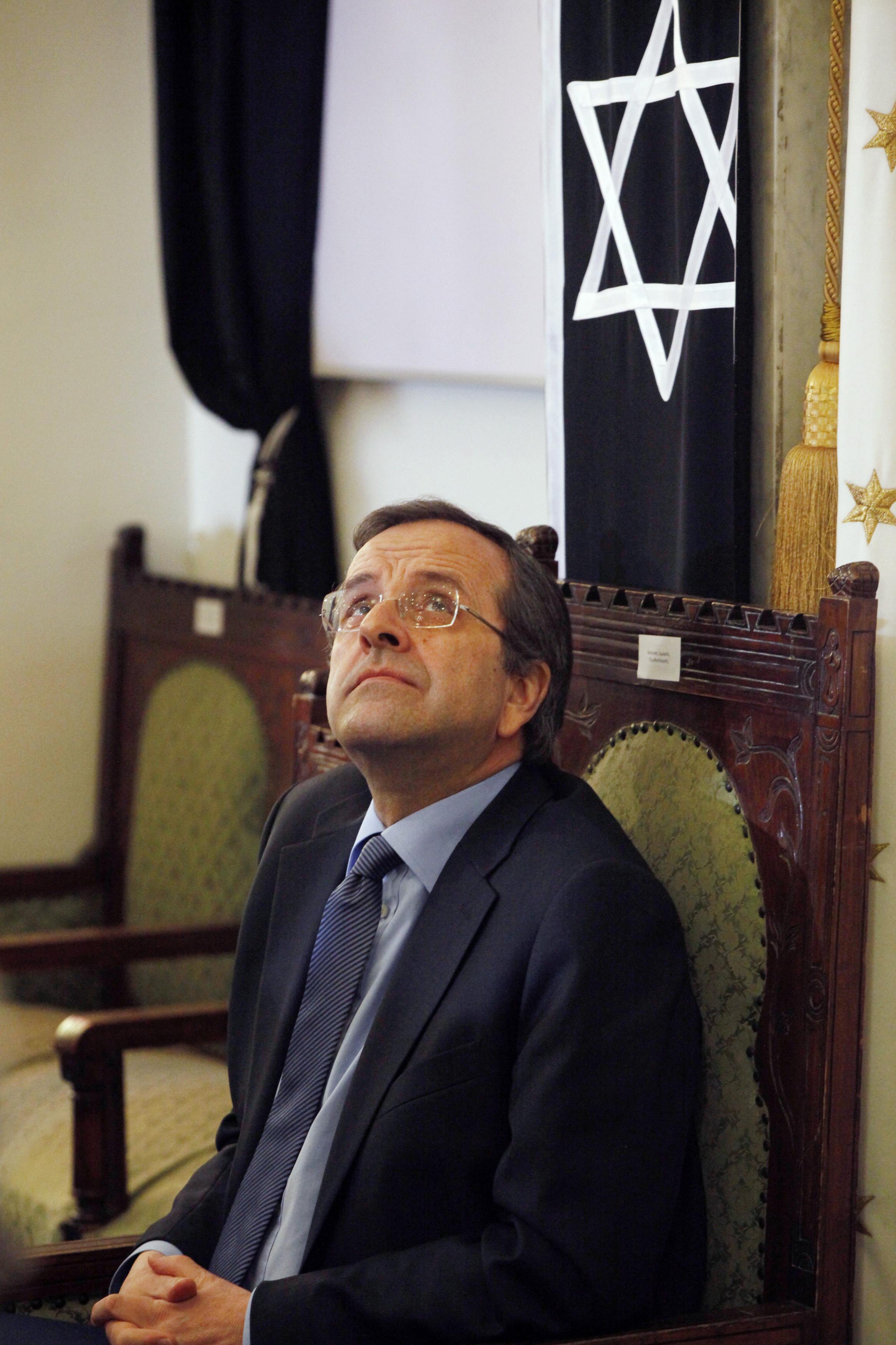 Greece's Prime Minister Antonis Samaras attends a ceremony marking the 70th anniversary of the first deportation of Jews from Thessaloniki to Auschwitz inside the Monastirioton synagogue
